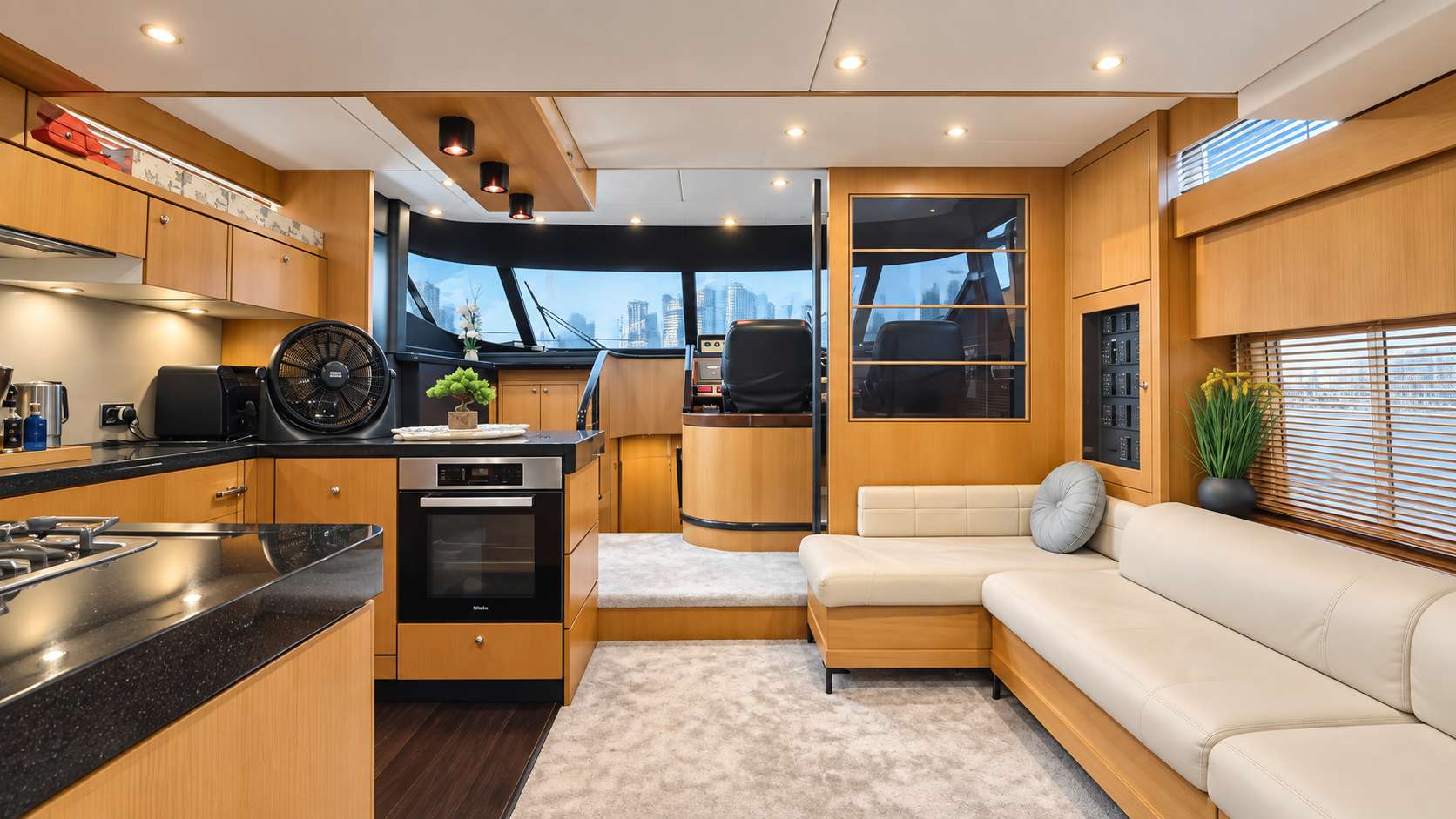 Empress 80 galley, dinette and lower helm with Dubai skyline view