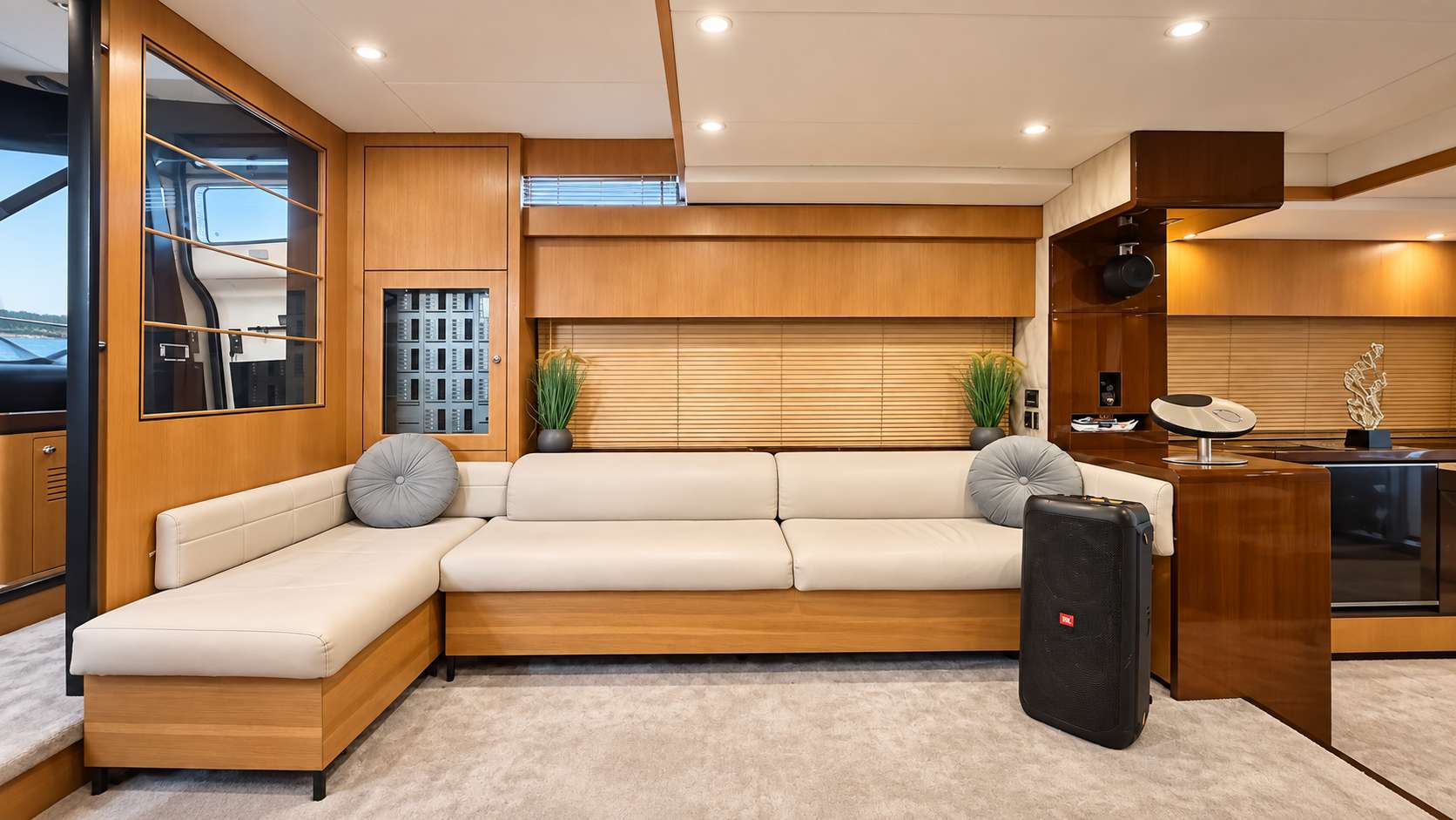 Empress 80 salon lounge with L-shaped sofa and sound system