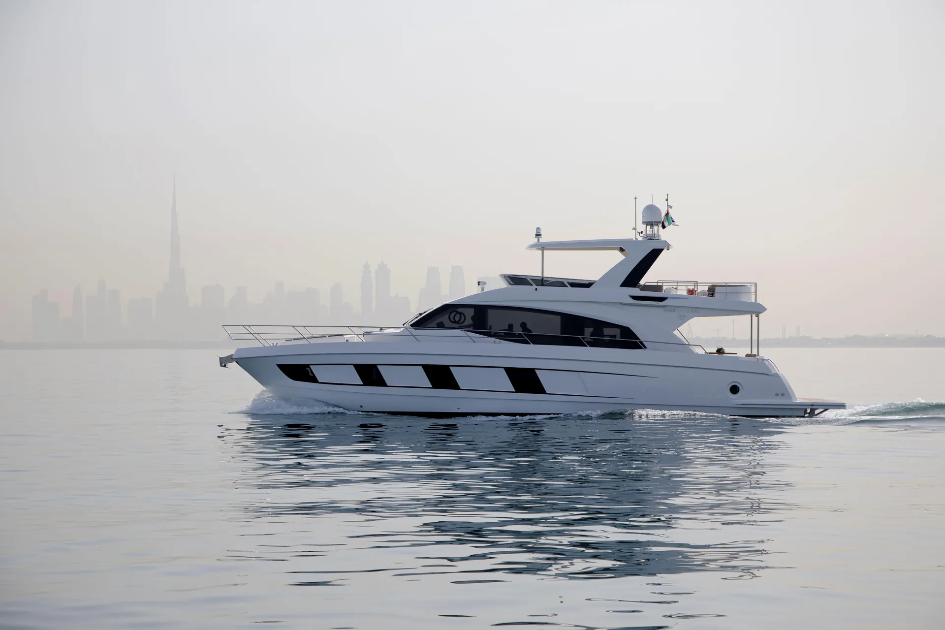 Alia 62 Majesty yacht with the Dubai skyline – starboard profile