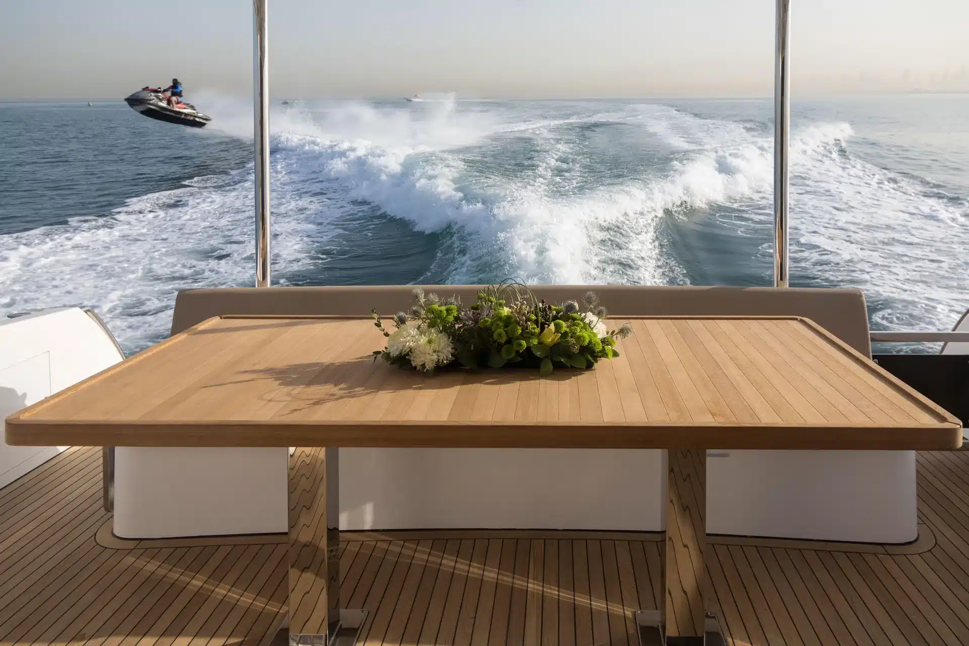 Alia 62 aft deck teak dining table with jet ski