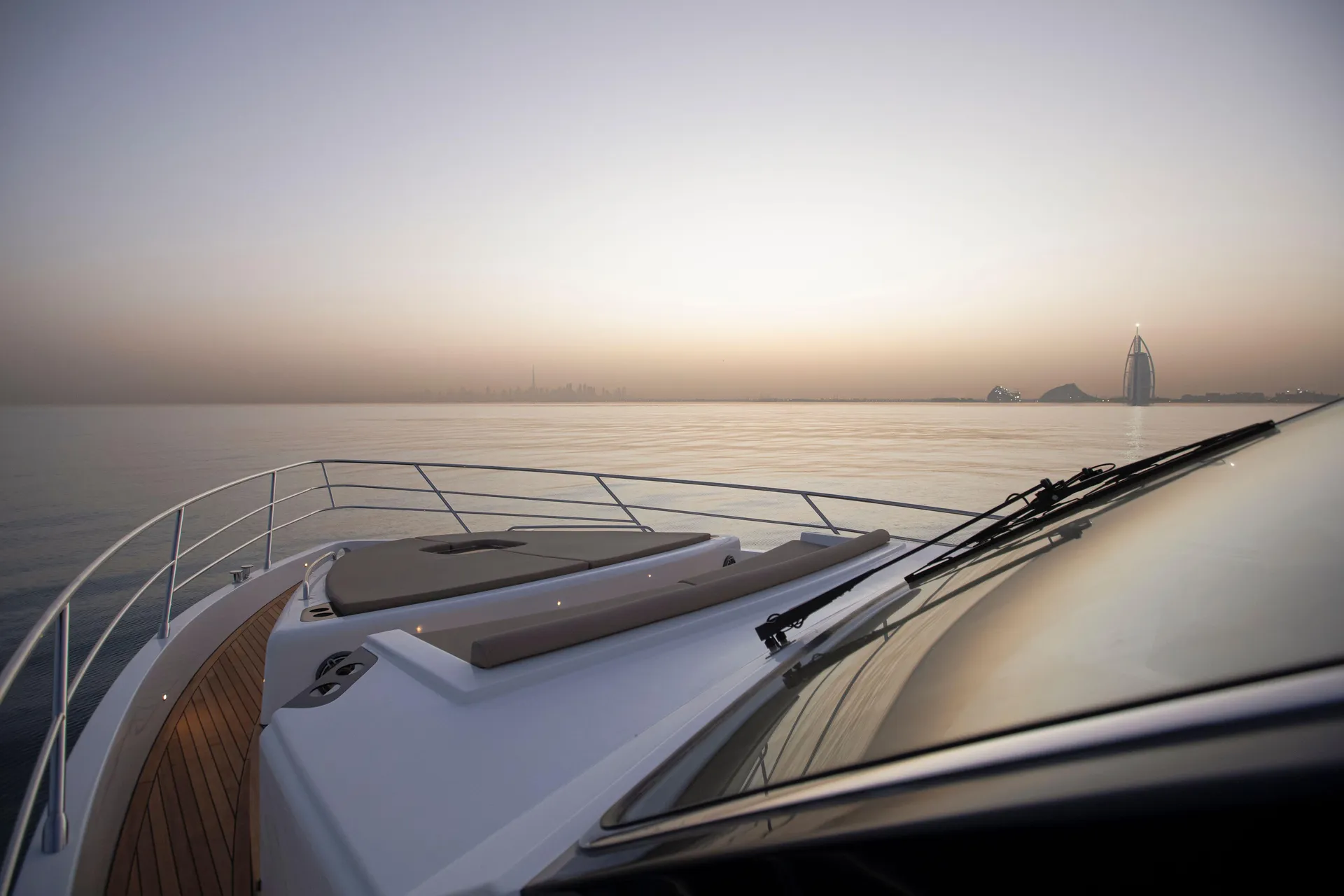 Alia 62 bow sunpads at sunset with Burj Al Arab