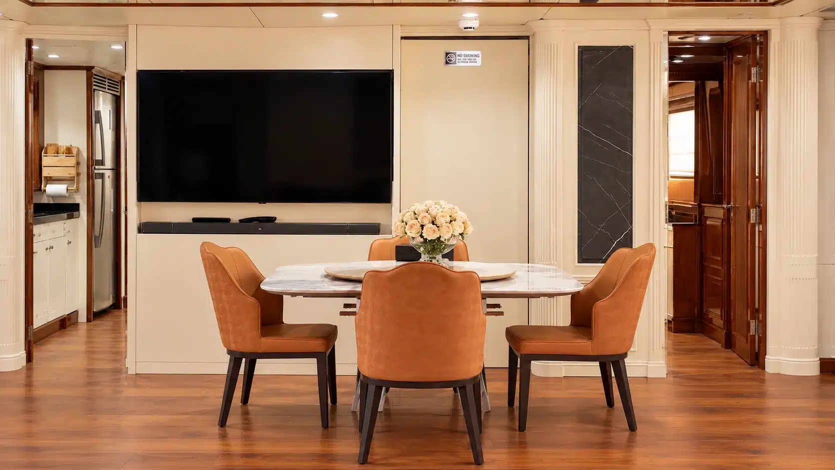 Benetti 120 yacht indoor dining table and television