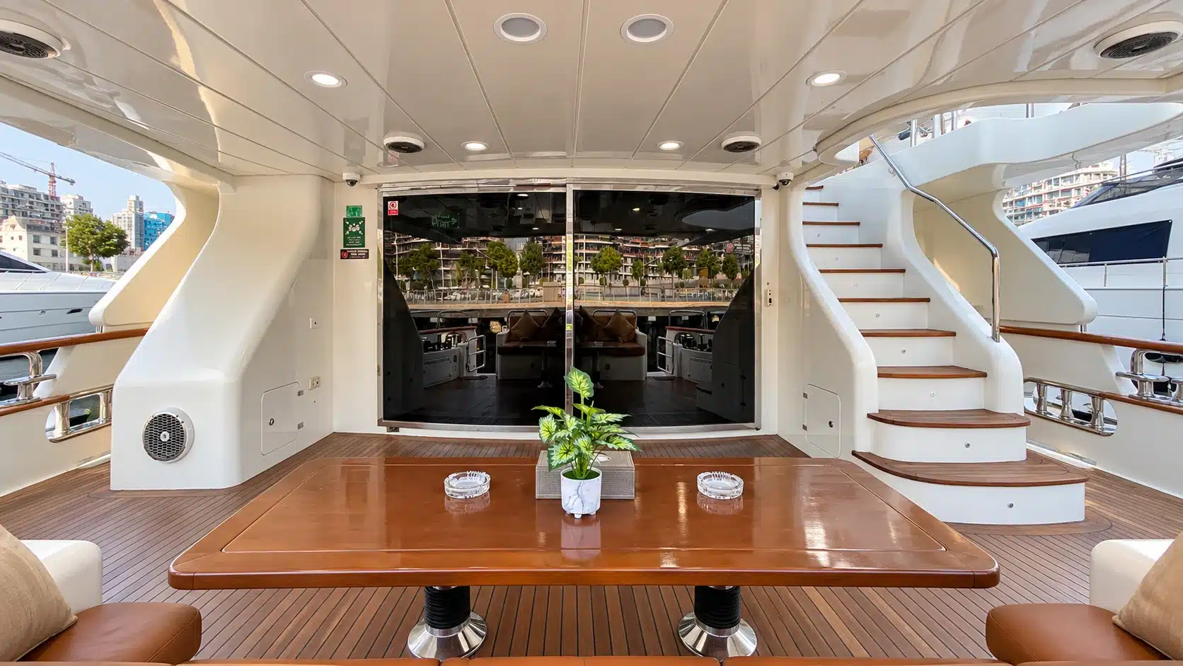 Benetti 120 yacht aft deck dining table and staircase